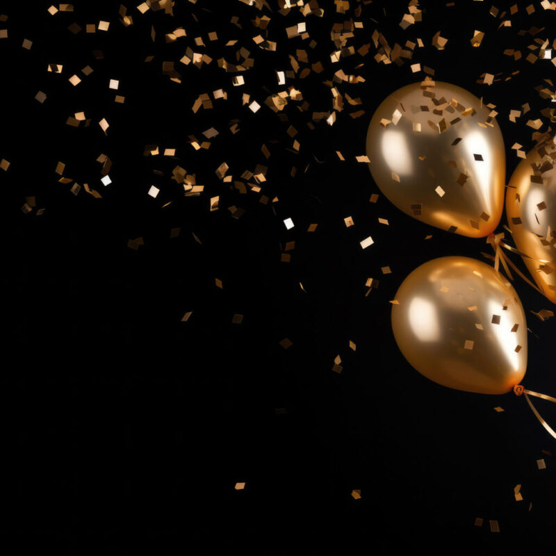 Gold balloons with gold confetti falling down over black backgro